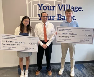 Phoebe Anthony and Ethan Holson of Boston College High School pictured holding big checks with Joe Devito.