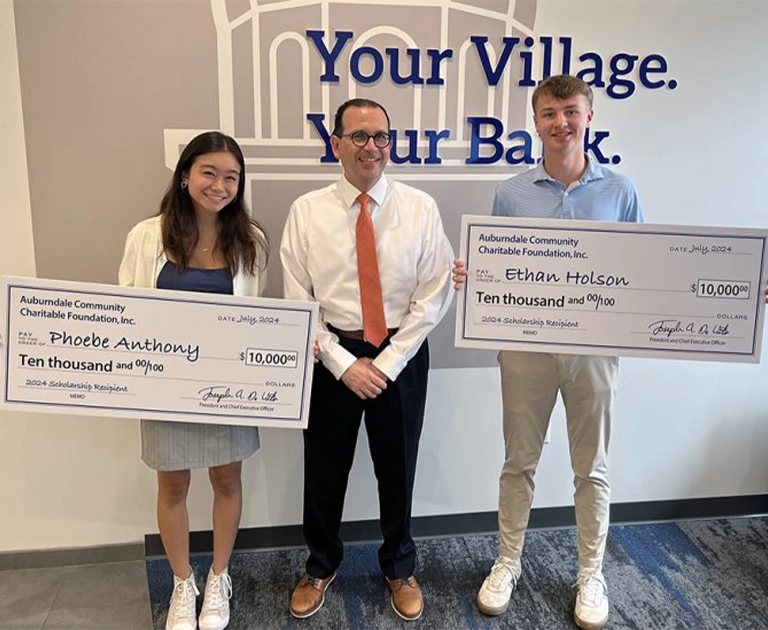Phoebe Anthony and Ethan Holson of Boston College High School pictured holding big checks with Joe Devito.