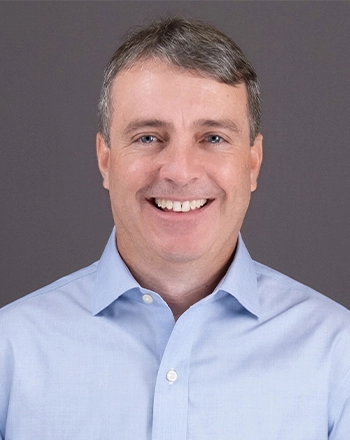 Pictured is the headshot of Eric Boecher.