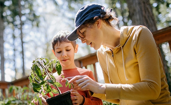 A mother and child gardening on the porch